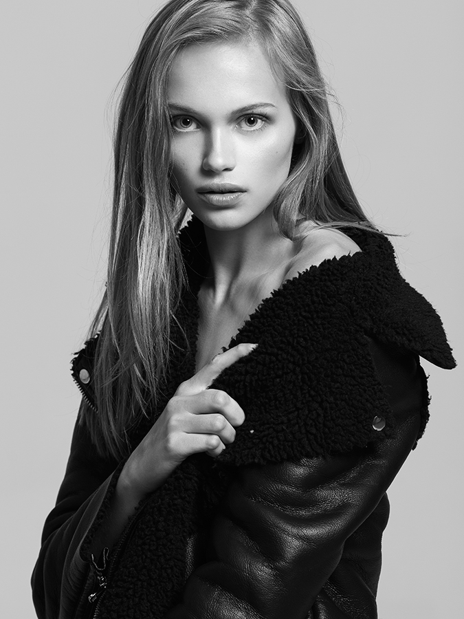 Freedom and Next Model Mae Van Der Weide looks towards camera over shoulder in leather jacket with fuzzy collar in headshot photographed by Joshua Pyles