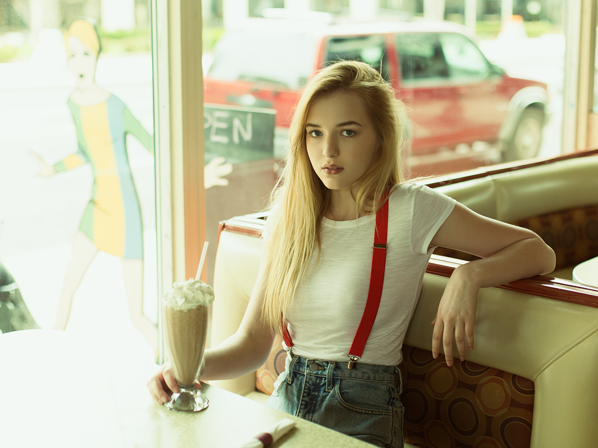 Model Nichole Gearhart with a milkshake in a retro deco diner photographed by Joshua Pyles
